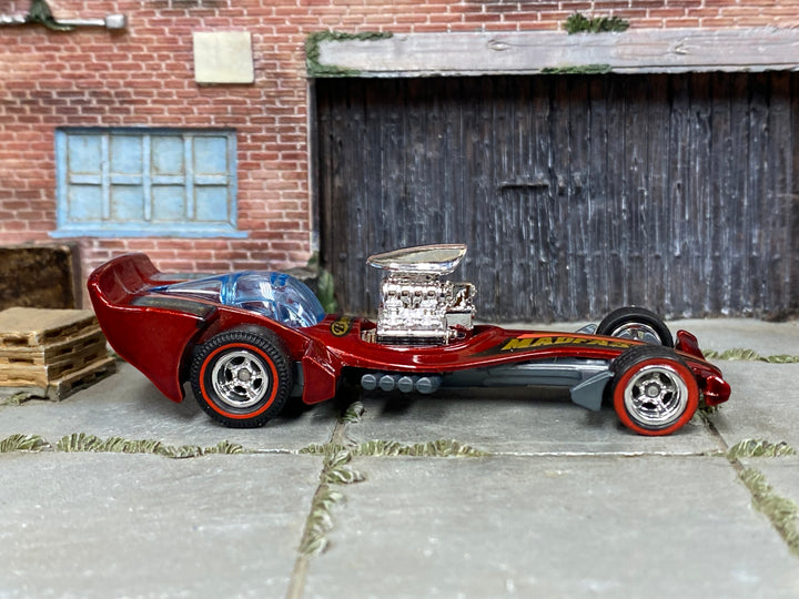 Custom Hot Wheels Madfast metallic red finish with black and gold graphics, blue canopy, and exposed chrome engine with chrome wheels with redline tires and rubber tires - side view