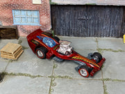 Custom Hot Wheels Madfast metallic red finish with black and gold graphics, blue canopy, and exposed chrome engine with chrome wheels with redline tires and rubber tires - three-quarter view