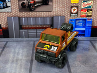 Mercedes-Benz Unimog custom Hot Wheels, front view with yellow glazing and off-road tires