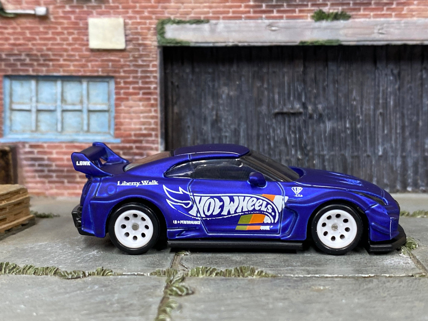 Satin-blue Nissan LB Works 35GT-RR custom Hot Wheels, side view with white mag wheels