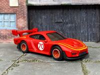 Satin-red Porsche 935 custom Hot Wheels number 70, front three-quarter view