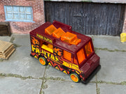 Custom Hot Wheels Quick Bite burgundy Fuego Fajitas food-truck livery with orange details with orange wheels with lime-green rim accents and rubber tires - three-quarter view