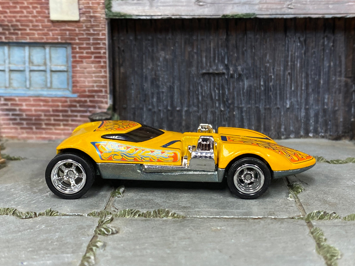 Custom Hot Wheels Screamin' Hauler yellow finish with orange flame graphics and exposed chrome engines with chrome wheels and rubber tires - side view