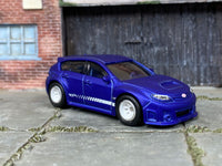 Subaru WRX STI custom Hot Wheels, front three-quarter view with white race wheels