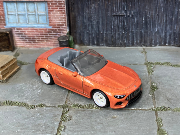 Custom Matchbox Mercedes-AMG SL 63, Metallic orange with white wheels, three-quarter view