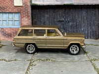 1964 Jeep Wagoneer gold custom Matchbox with chrome wheels and rubber tires, view 1