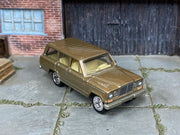 Custom Matchbox 1964 Jeep Wagoneer, Gold with chrome wheels, three-quarter view