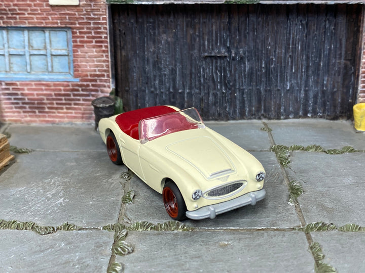 Custom Matchbox 1963 Austin-Healey 3000 MK2 in cream with red wheels and rubber tires, three-quarter view