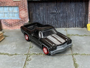 Custom Matchbox 1970 Chevrolet El Camino SS, Black and silver with red wheels, three-quarter view