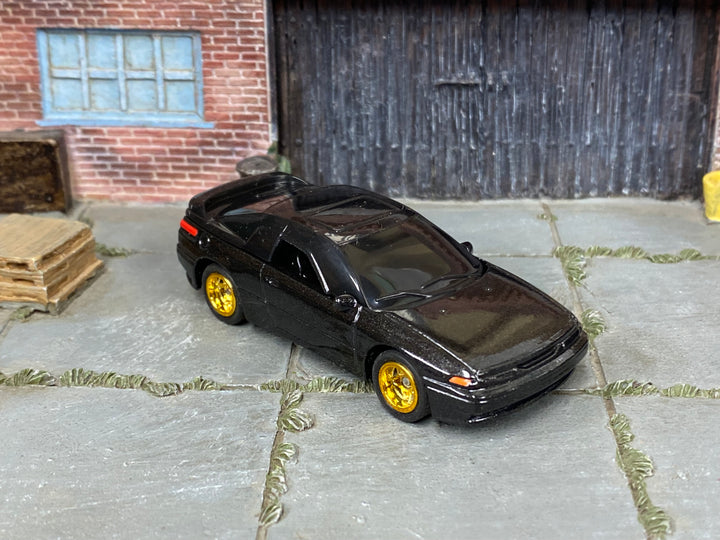 Custom Matchbox Subaru SVX, Black with gold wheels, three-quarter view