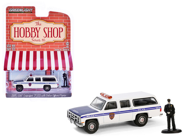 1985 GMC Suburban 2500 "New York City Transit Police Department" White with Blue Stripes and Police Officer Figure "The Hobby Shop" Series 16 1/64 Diecast Model Car by Greenlight