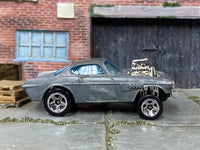 Disassembled Volvo P1800 Gasser kit with bare-metal body and raised rolling chassis