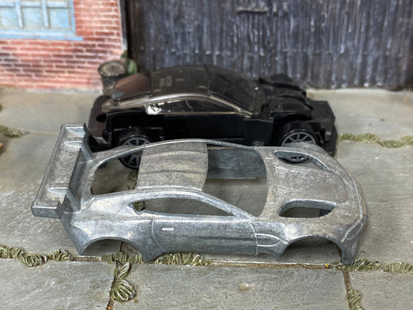 Aston Martin Vantage GTE DIY Hot Wheels kit disassembled with bare-metal body and components