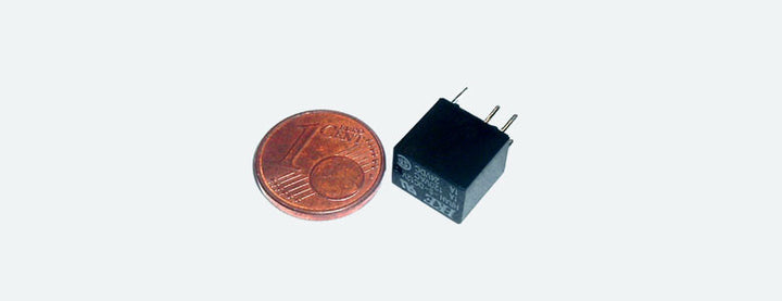 ESU 51963 miniature 1 amp relay; coin shown for size comparison.