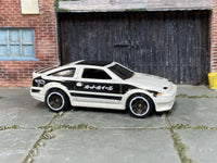 Hot Wheels 2013 Toyota AE-86 Corolla white and black left-side view