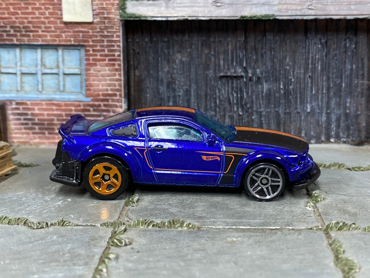 Hot Wheels 2010 Ford Mustang GT purple and orange loose car with mixed wheels, right-side view