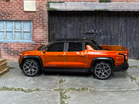 Hot Wheels 2022 GMC Hummer EV orange left-side view