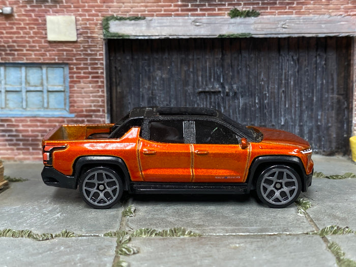 Hot Wheels 2022 GMC Hummer EV orange right-side view