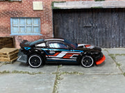 2024 Hot Wheels Gazella R black Nightburnerz loose car, right-side view