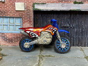 Hot Wheels 2024 HW450F red and blue left-side view