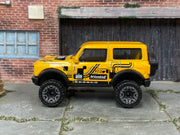 Hot Wheels '21 Ford Bronco metallic yellow number 2, left side view