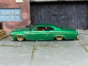 Hot Wheels '65 Chevy Impala green pinstripe loose car, left-side view