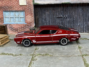 Hot Wheels '69 Mercury Cyclone metallic red and white, left side view showing loose-car condition
