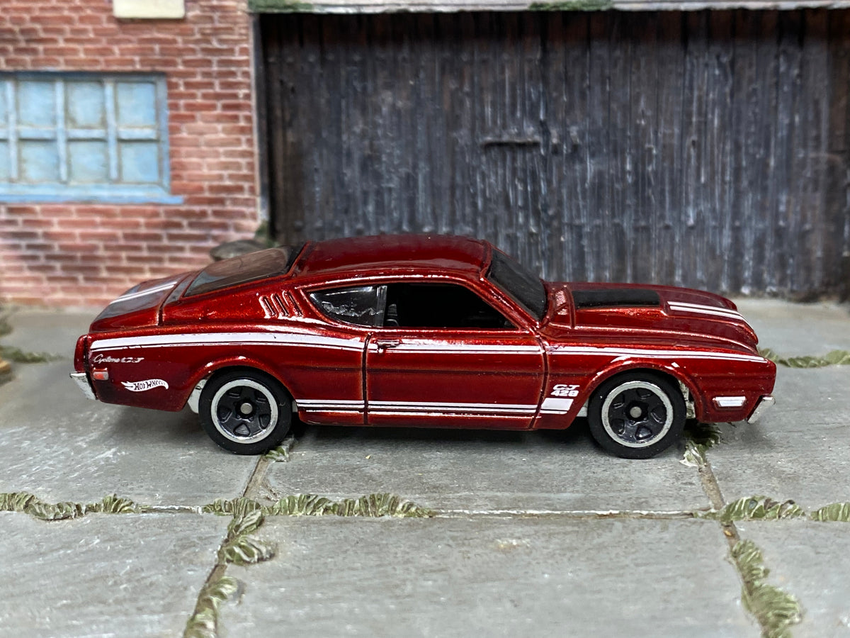 Hot Wheels '69 Mercury Cyclone metallic red and white, right side view showing loose-car condition