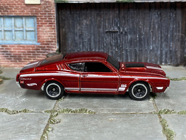 Hot Wheels '69 Mercury Cyclone metallic red and white, right side view showing loose-car condition