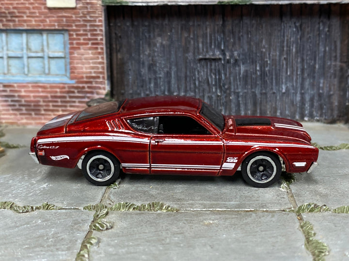 Hot Wheels '69 Mercury Cyclone metallic red and white, right side view showing loose-car condition