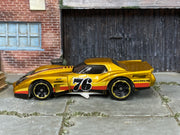 Hot Wheels ’76 Greenwood Corvette gold number 76 — left side view