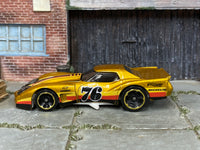 Hot Wheels ’76 Greenwood Corvette gold number 76 — left side view