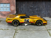 Hot Wheels ’76 Greenwood Corvette gold number 76 — right side view