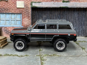 Hot Wheels '88 Jeep Wagoneer gray black and red, left side view