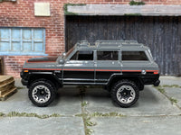 Hot Wheels '88 Jeep Wagoneer gray black and red, left side view