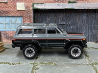 Hot Wheels '88 Jeep Wagoneer gray black and red, right side view