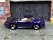 Hot Wheels '99 Mustang metallic purple with tan interior, left side view