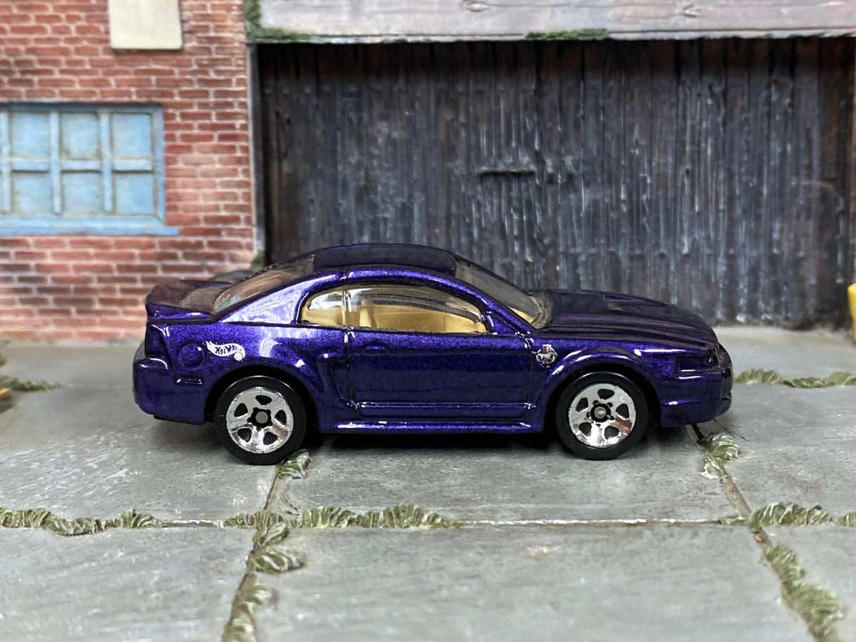 Hot Wheels '99 Mustang metallic purple with tan interior, right side view