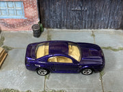 Hot Wheels '99 Mustang metallic purple with tan interior, top view