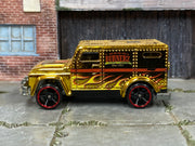 Hot Wheels Armored Truck gold Chrome Burnerz with red-rim wheels, left side view