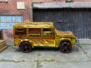 Hot Wheels Armored Truck gold Chrome Burnerz with red-rim wheels, right side view