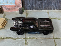 Hot Wheels Batmobile gloss black with black disc wheels — top view