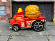 Hot Wheels Buns of Steel orange-red burger truck, left side view