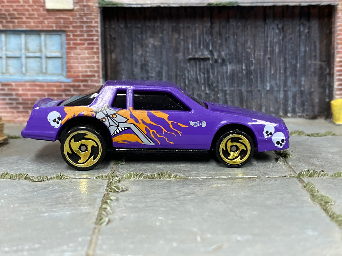 Hot Wheels Chevy Stocker purple skulls and flames loose car, right-side view
