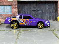 Hot Wheels Chevy Stocker purple skulls and flames loose car, right-side view