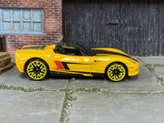 Hot Wheels Corvette C6 Convertible yellow with black and red stripes, right side view