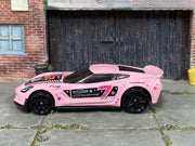 Hot Wheels Corvette C7 Z06 pink number 7 and star graphics, left side view