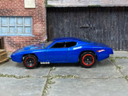 Hot Wheels Custom Otto metallic blue with red-rimmed black wheels, left side view