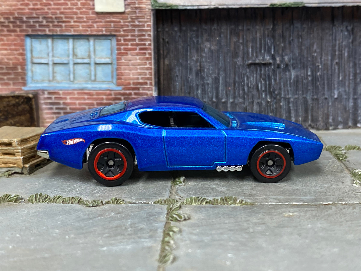 Hot Wheels Custom Otto metallic blue with red-rimmed black wheels, right side view