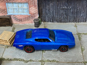 Hot Wheels Custom Otto metallic blue with red-rimmed black wheels, top view